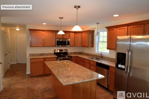 A kitchen with wooden cabinets and granite countertops.