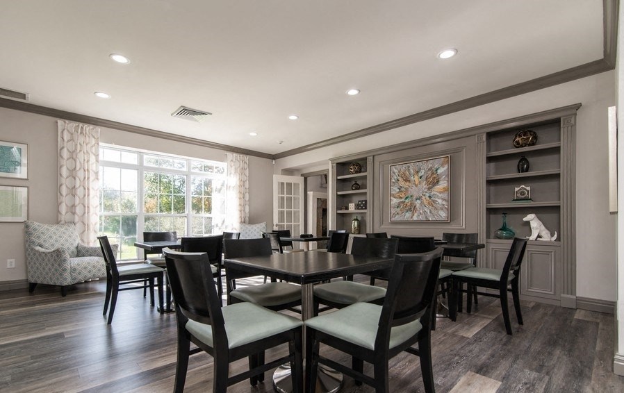 a dining room with a large table and chairs