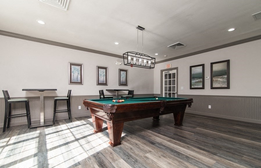 a game room with a pool table and a bar