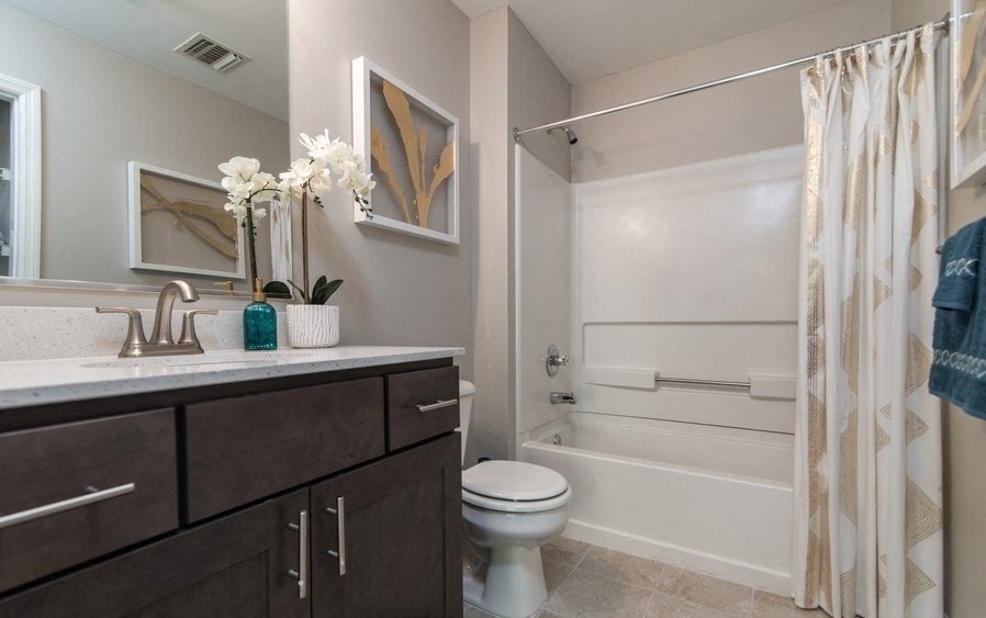 a bathroom with a shower and a sink and a toilet