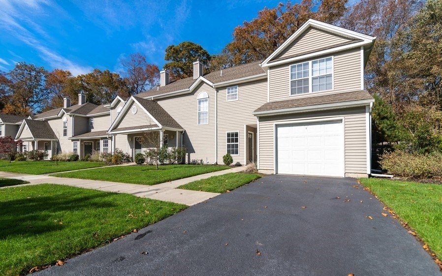 a house with a white garage door on a driveway