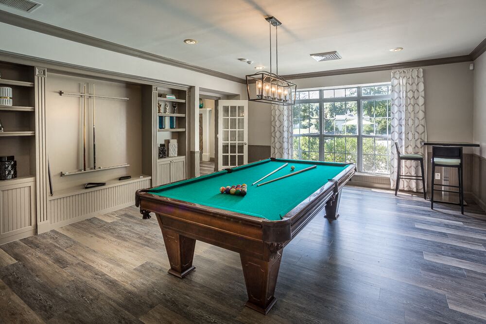 a pool table in a game room with a