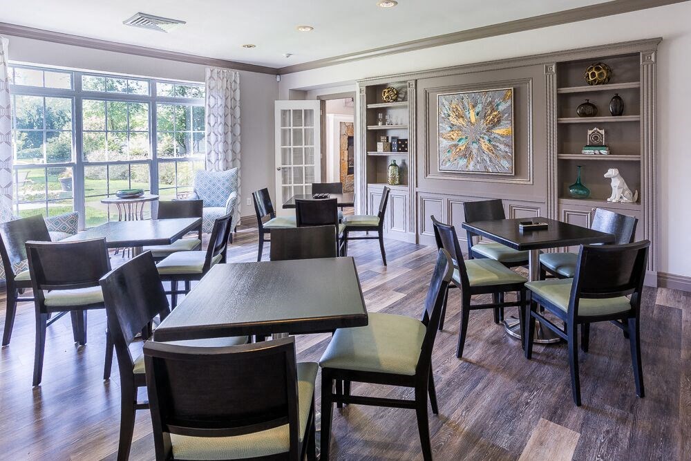 a dining room with tables and chairs and a window