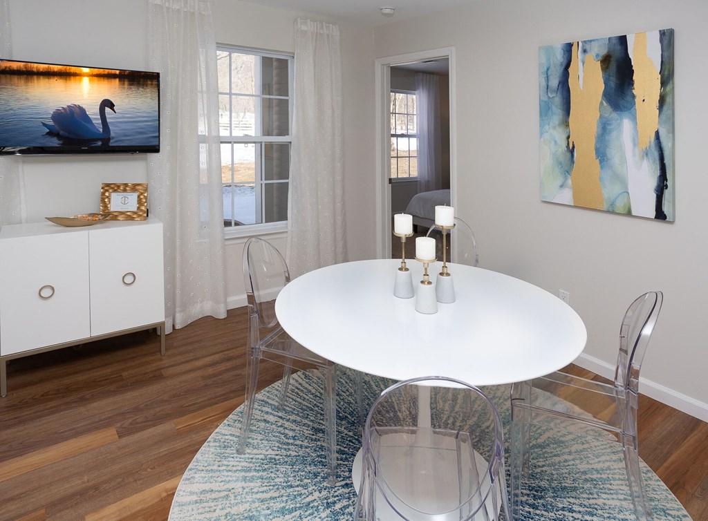 a dining room with a white table and chairs