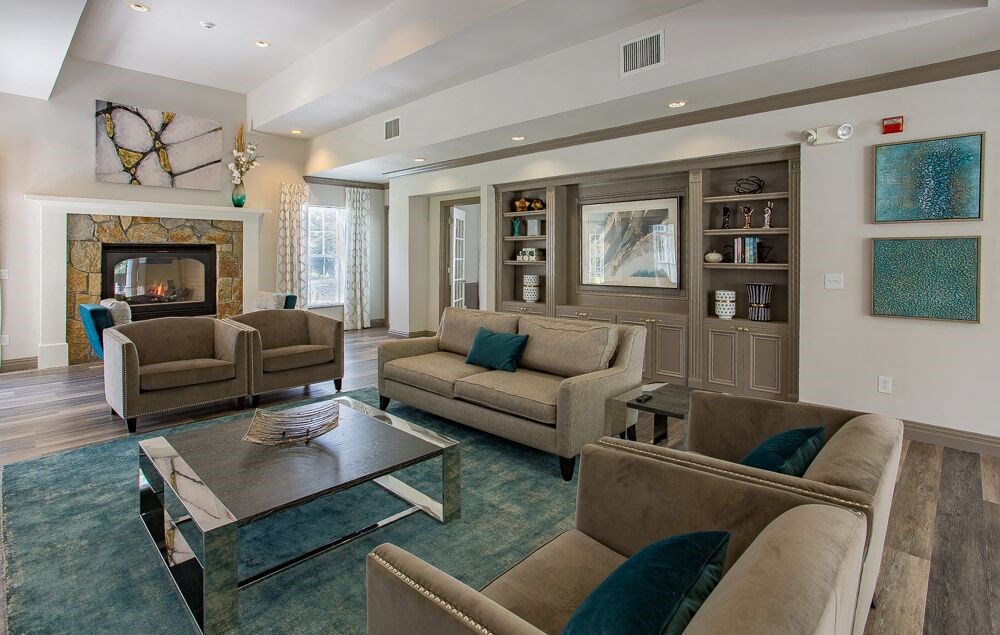 a living room with couches and chairs and a fireplace