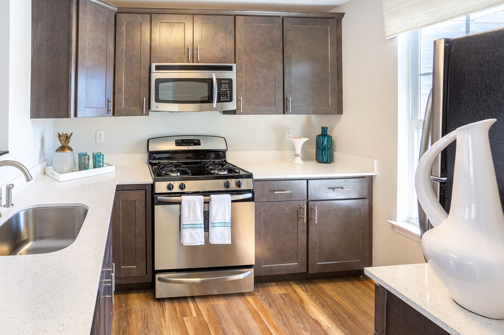 a kitchen with stainless steel appliances and wooden cabinets