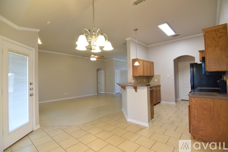 A room with a ceiling fan and a window letting in natural light.