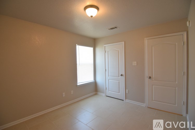 A room with two doors and a window.