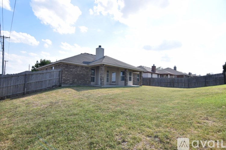 A house with a fence in front of it is for sale.