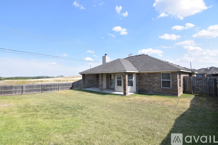 A house with a fence and a grassy yard is for sale.
