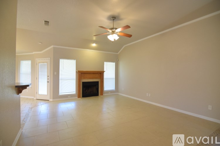 A house with a fence and a grassy yard.