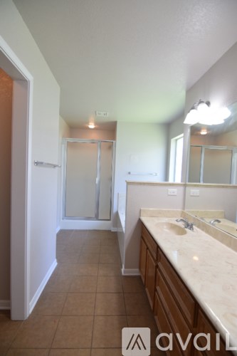 A kitchen with a white counter and wooden cabinets.
