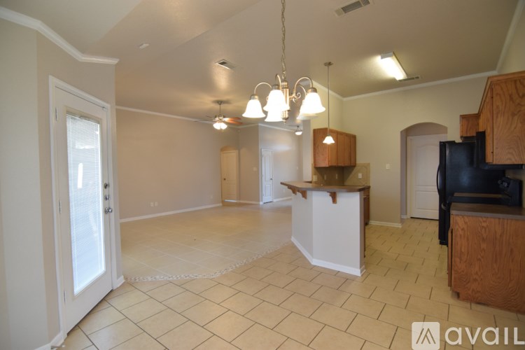 A living room with a white door and a black couch.