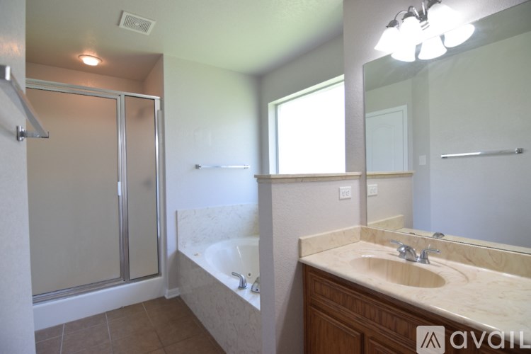 A room with a door, a window, and a chandelier.