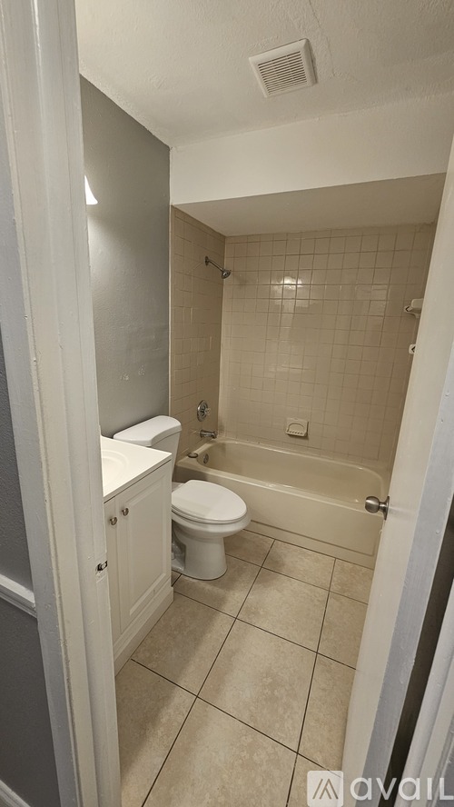 A bathroom with a toilet, sink, and shower.
