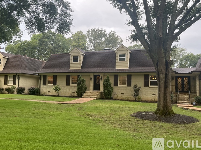 A house with a tree in front of it.