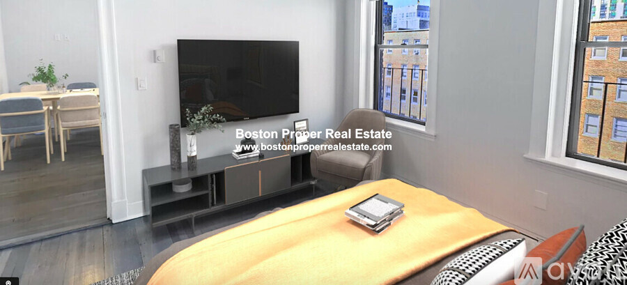 A living room with a television and a table with a book on it.
