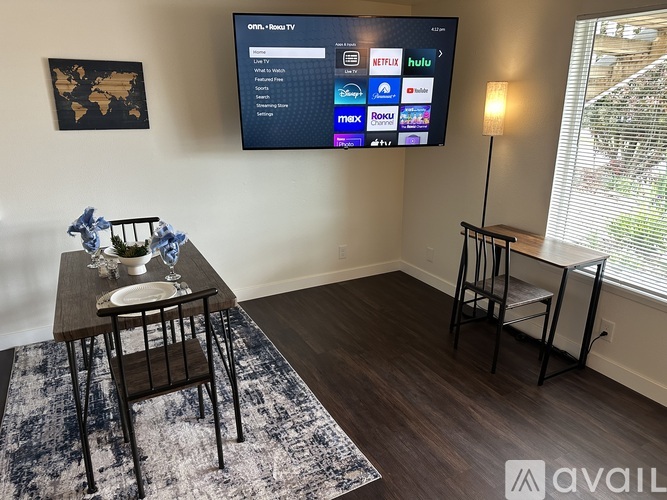 A living room with a flat screen TV displaying a Netflix interface.