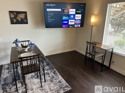 A living room with a flat screen TV displaying a Netflix interface.