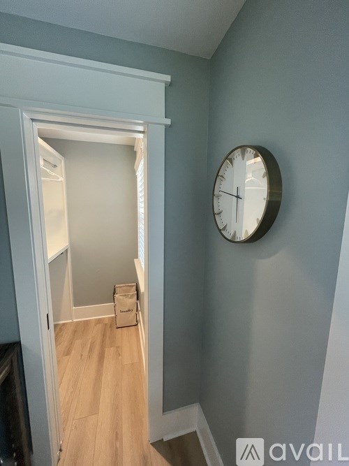 A clock hangs on a wall above a doorway.