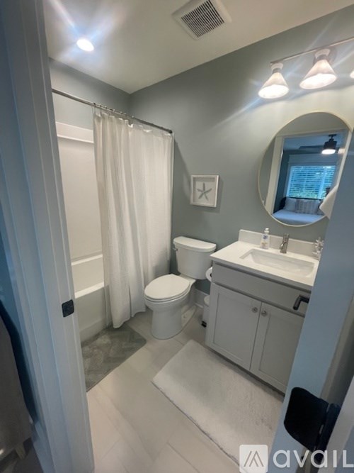A bathroom with a toilet, sink, and shower.