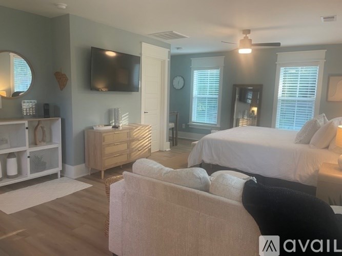 A bedroom with a bed, dresser, and mirror.