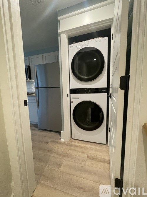 A white washer and dryer in a small room.