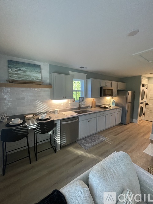 A kitchen with a dining table and chairs.
