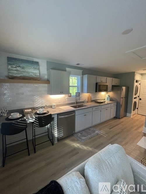 A kitchen with a dining table and chairs.