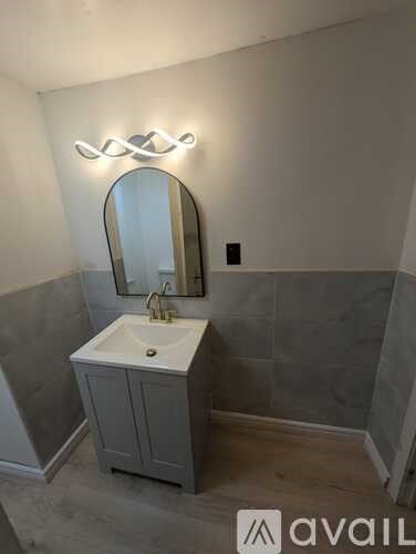 A bathroom with a sink and mirror.