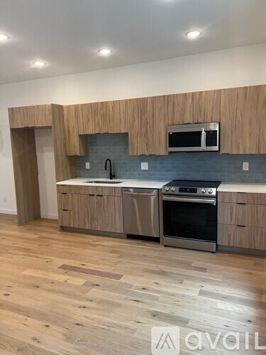 A kitchen with wooden cabinets and stainless steel appliances.