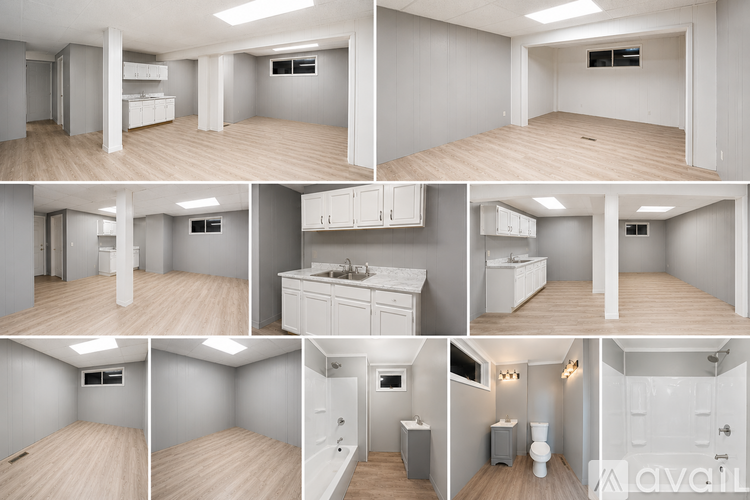 A kitchen with white cabinets and a marble countertop.