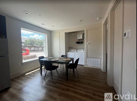 A kitchen with a dining table and chairs is available for rent.