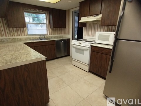 A kitchen with a white microwave oven and a white dishwasher.
