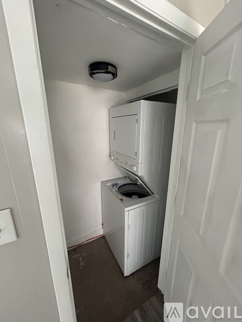 A small white kitchen with a dishwasher and a refrigerator.