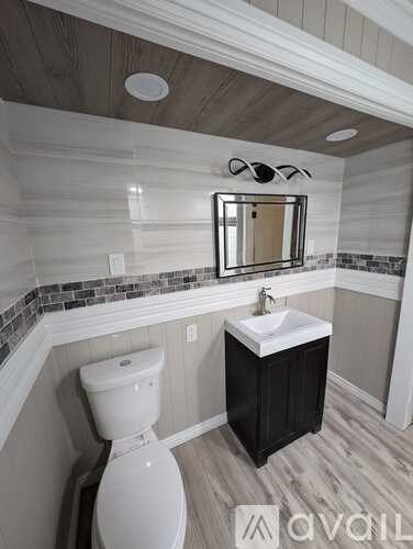 A bathroom with a white toilet and a white sink.
