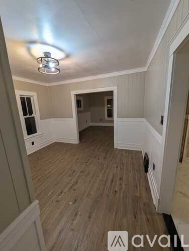 A room with wooden floors and white walls.