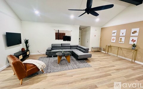 A living room with a grey sofa and a brown leather chair.