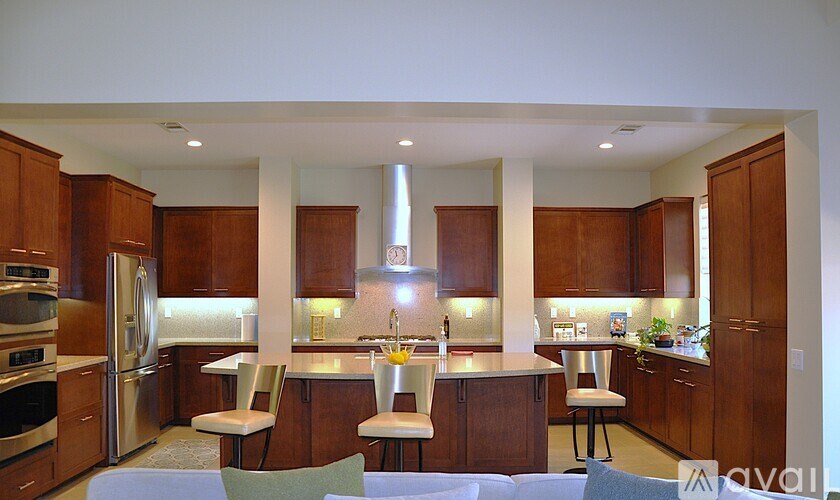 A kitchen with wooden cabinets and a central island.