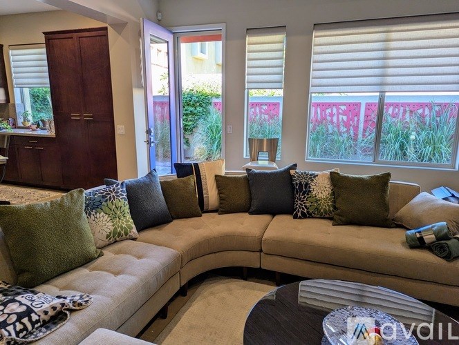 A living room with a beige sofa and a wooden cabinet.