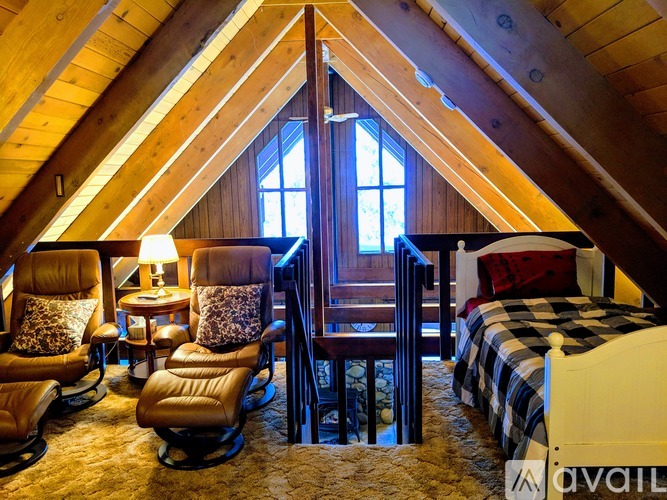 A cozy bedroom with a large bed and a window.