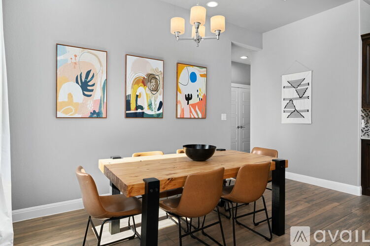 A dining room with a wooden table and chairs.