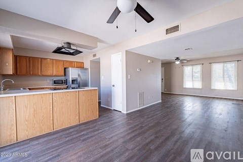 A kitchen with wooden cabinets and a refrigerator.