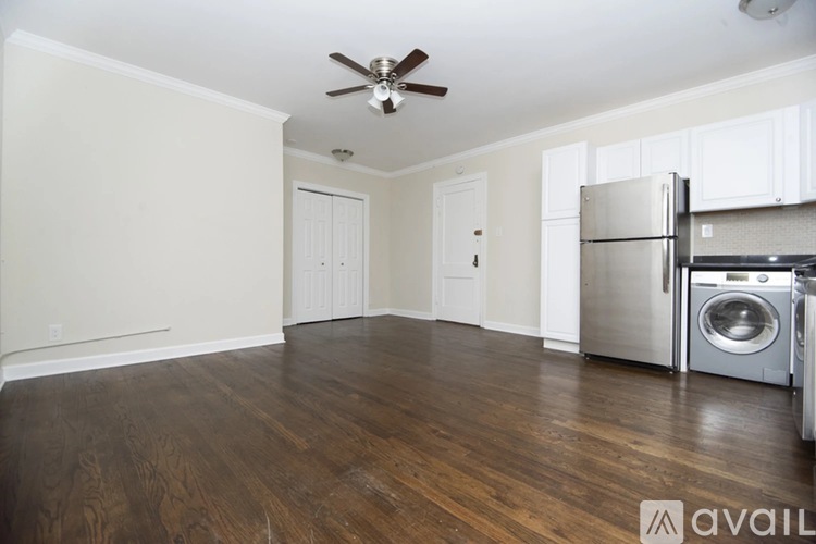 A kitchen area with a washing machine and a refrigerator.