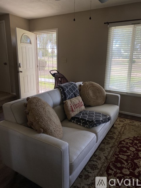A white couch with pillows in a living room.