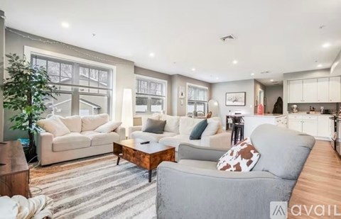 A living room with a grey couch and a wooden coffee table.