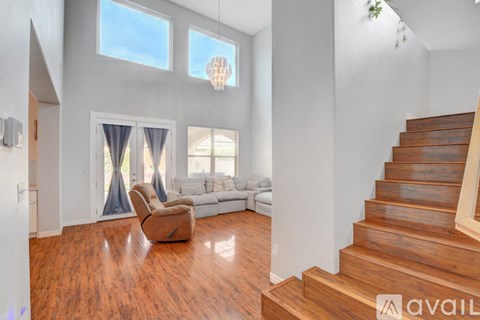 A living room with a brown chair and a white couch.