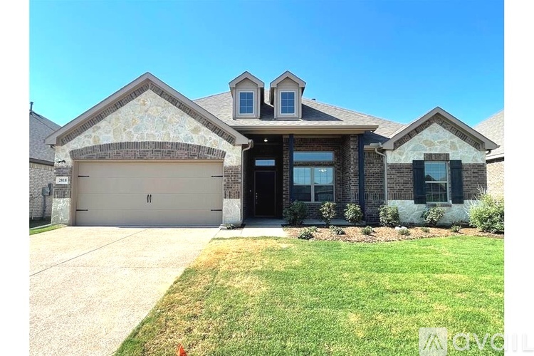 A house with a garage and a driveway in front.