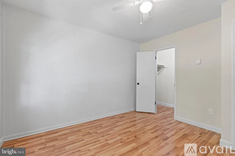 A room with wooden floors and a white door.
