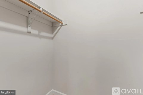 A white wall with a wooden beam and metal brackets.
